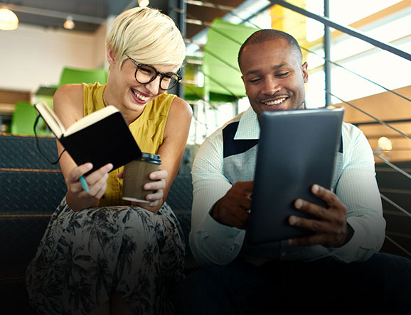 Work colleagues looking at tablet