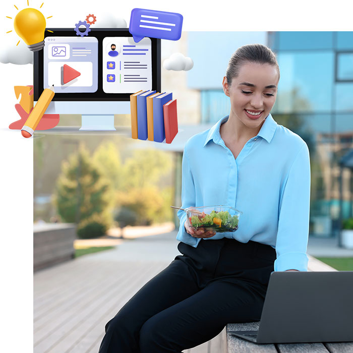 Lady sititng having lunch outside with laptop