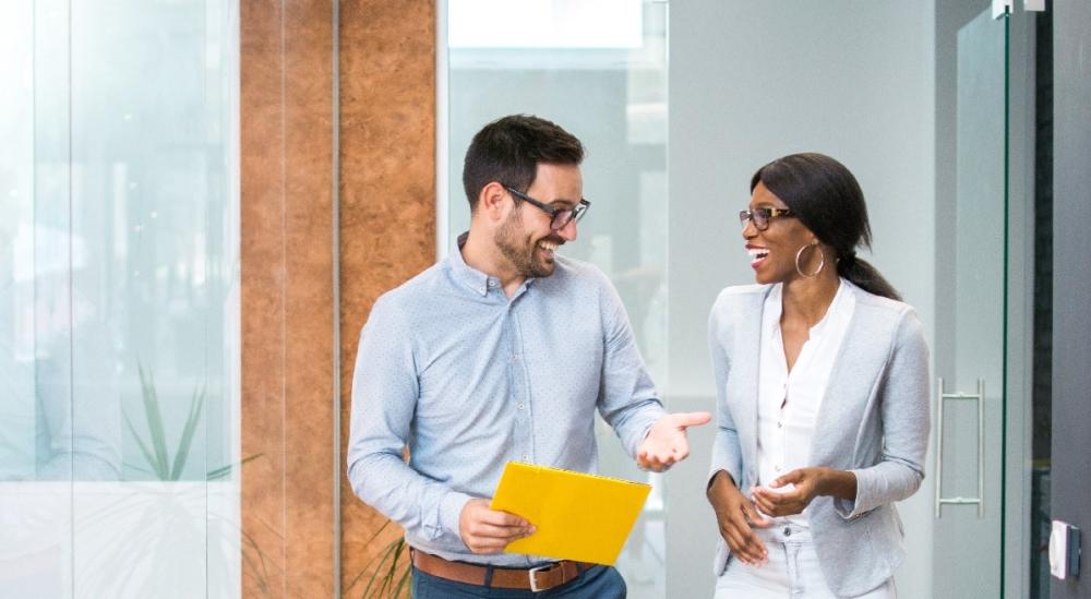 Two colleagues chatting at work