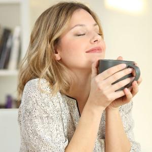 Lady smiling drinking coffee