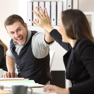 Office workers high fiving