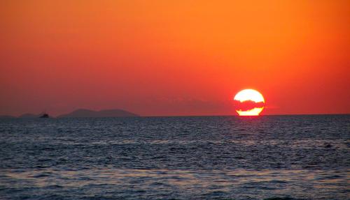 Sun setting over ocean