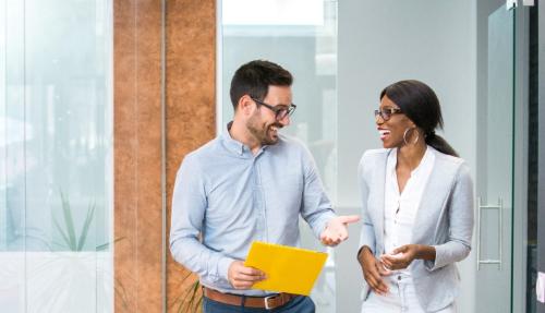 Two colleagues chatting at work